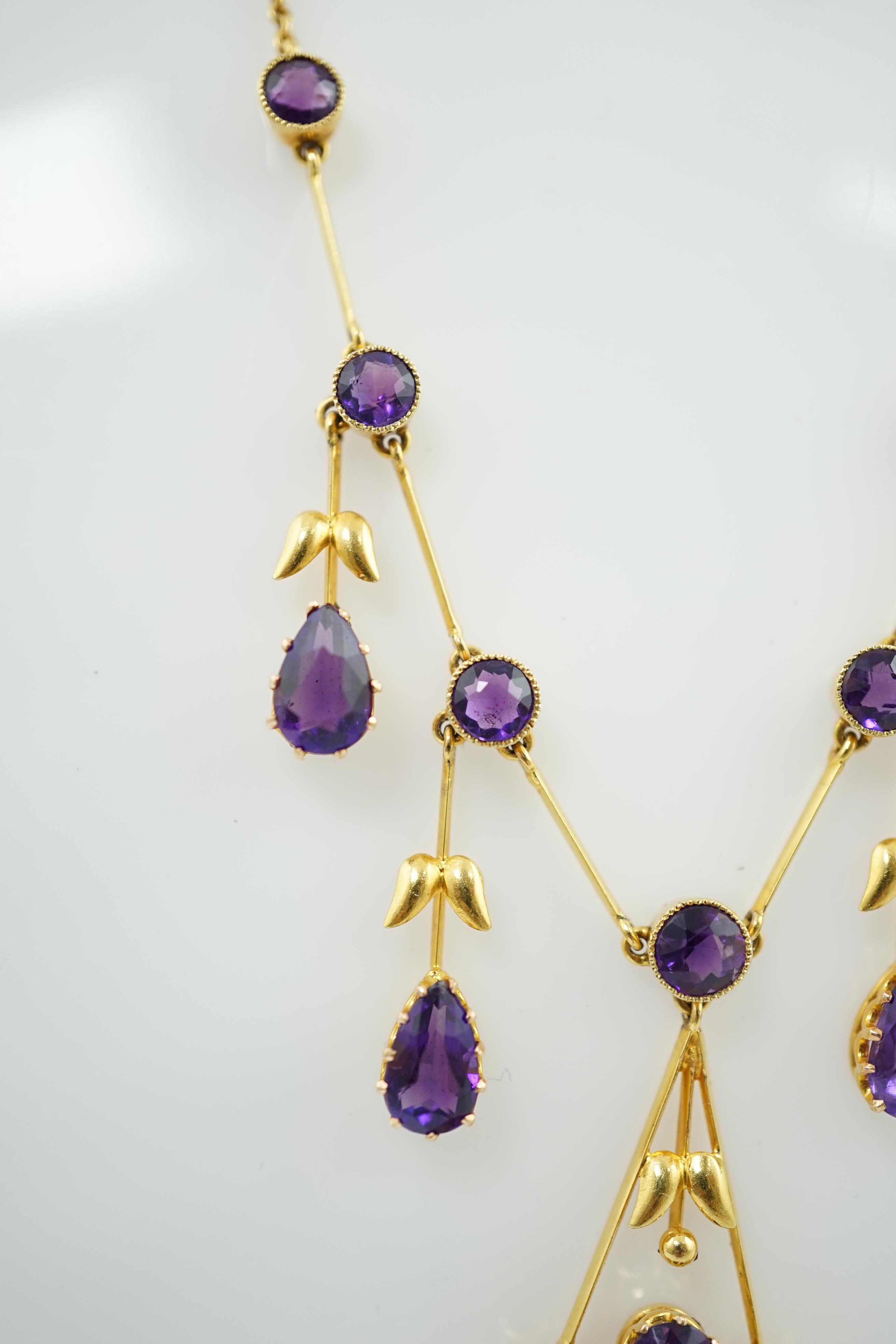 An Edwardian gold, and amethyst cluster drop pendant necklace